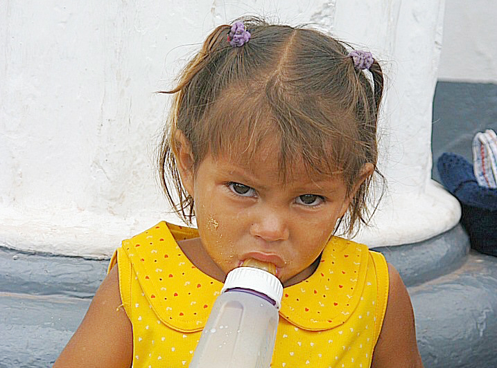 Young Honduras child drinking out of bottle