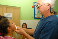 A Santa Rosa de Lima Clinic Doctor examines a patient